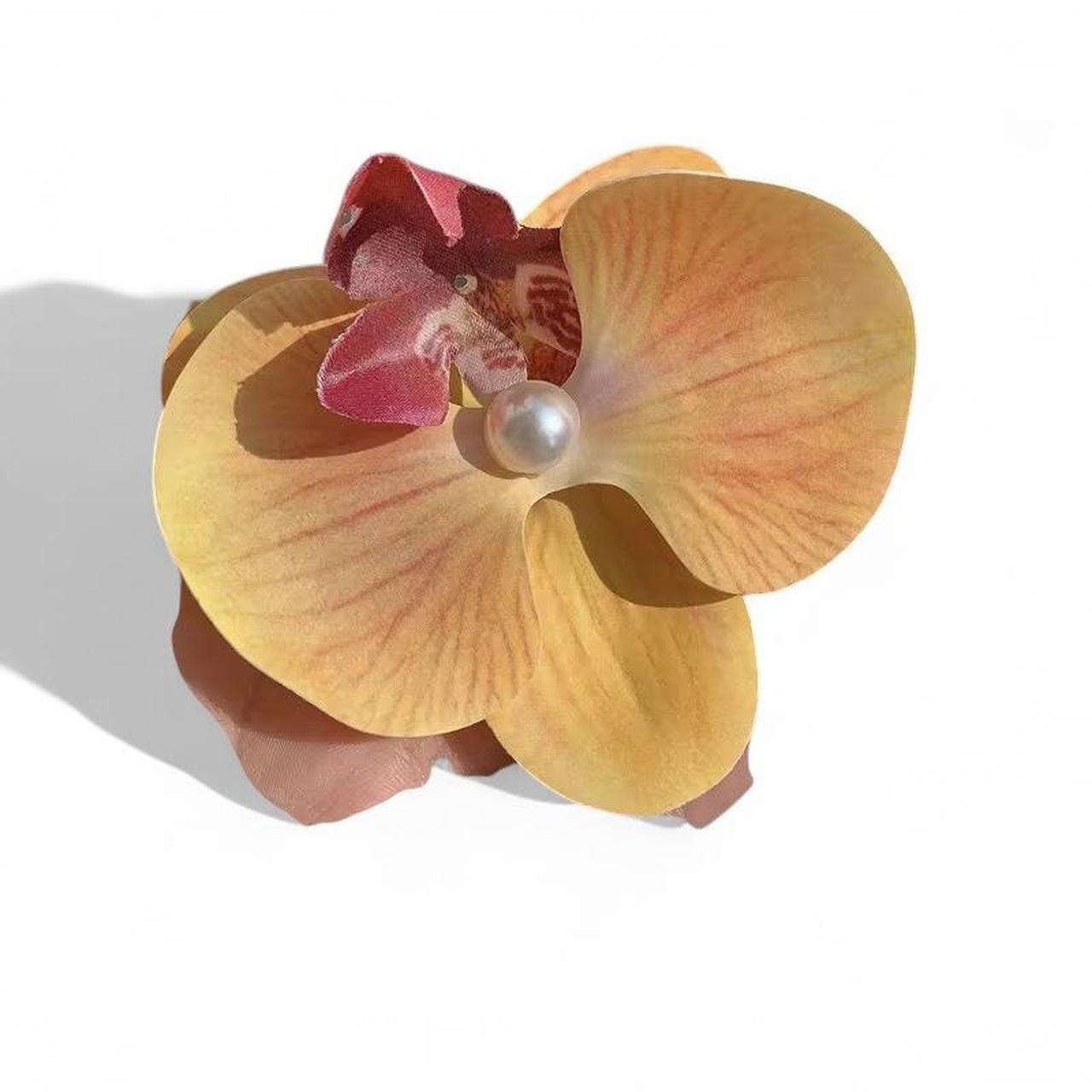 golden sunrise orchid with pearl brooch